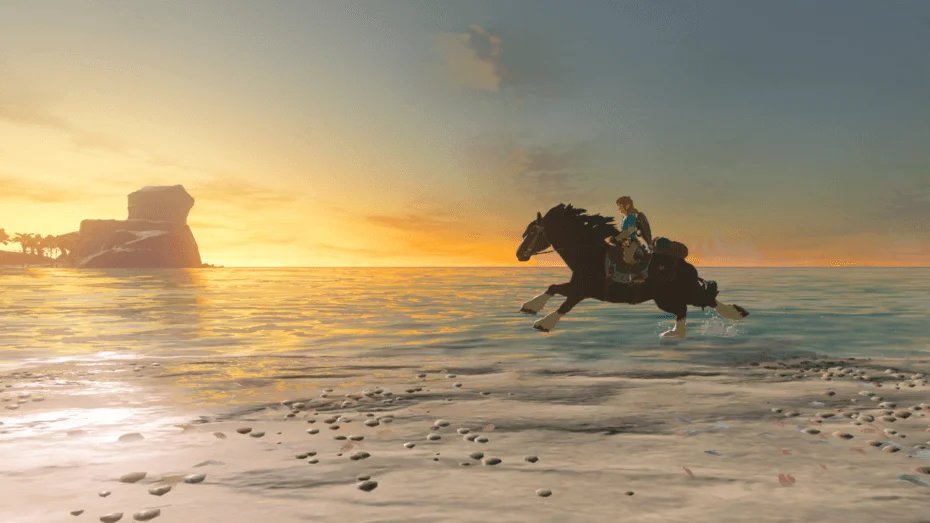 Breath of the Wild screenshot showing Link riding a galloping horse from right to left along the beach during a glorious sunset