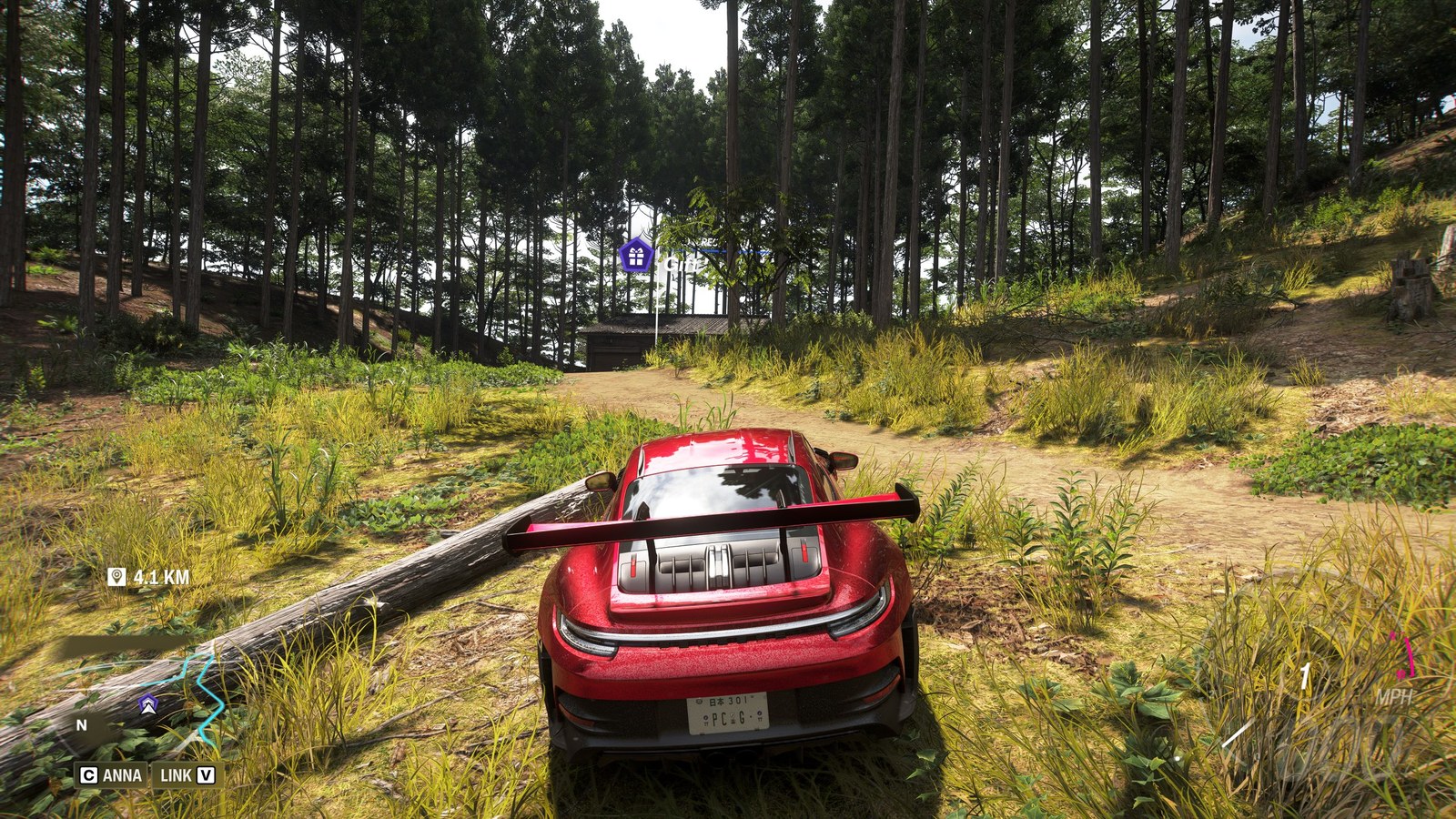 Forza Horizon 6 Barn Finds: A player parked on a dirt path ahead of an old barn in a forest.