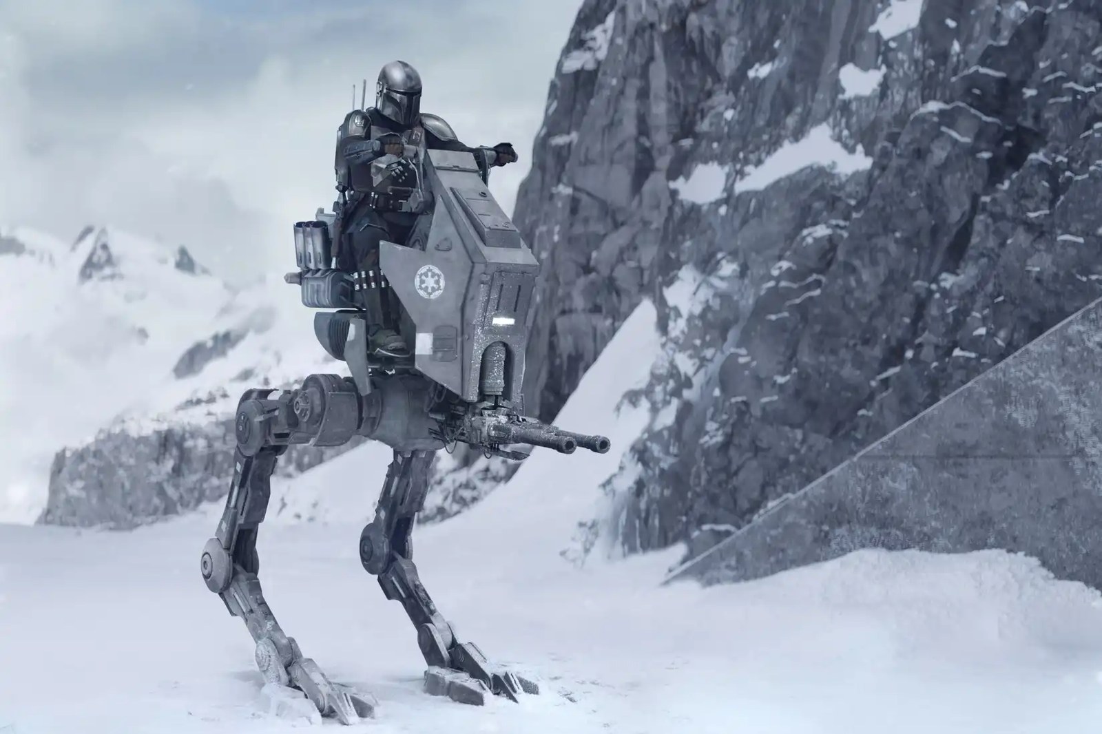 Din Djarin steers a walker on a snowy planet in The Mandalorian and Grogu