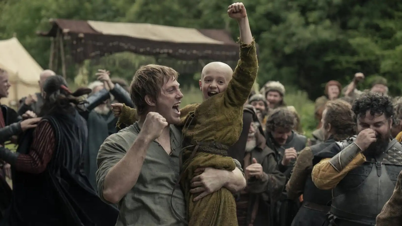 Dunk (Peter Claffey) holding Egg (Dexter Sol Ansell) as they cheer in A Knight of the Seven Kingdoms