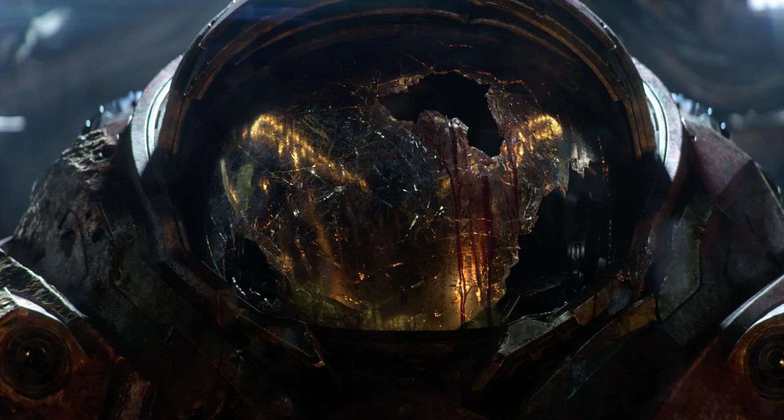 Close-up of a damaged metallic suit of armor with a shattered, reflective helmet showing internal glowing lights and streaks of blood.
