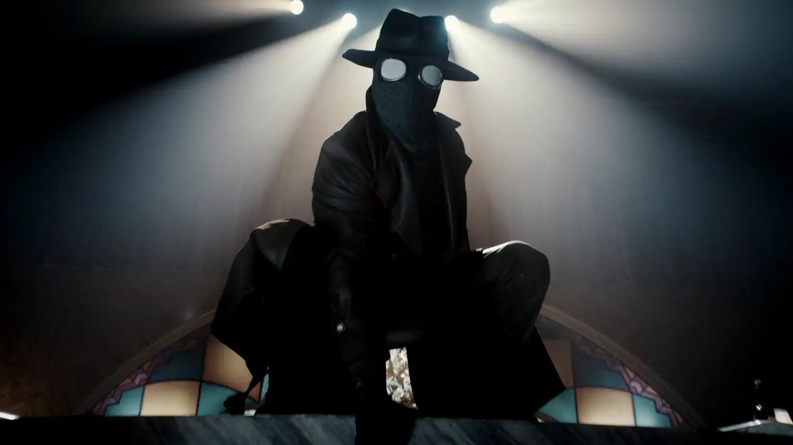 Spider-Noir (Nic Cage) wearing a black mask with white eyes and a fedora perches in front of stained glass in Spider-Noir