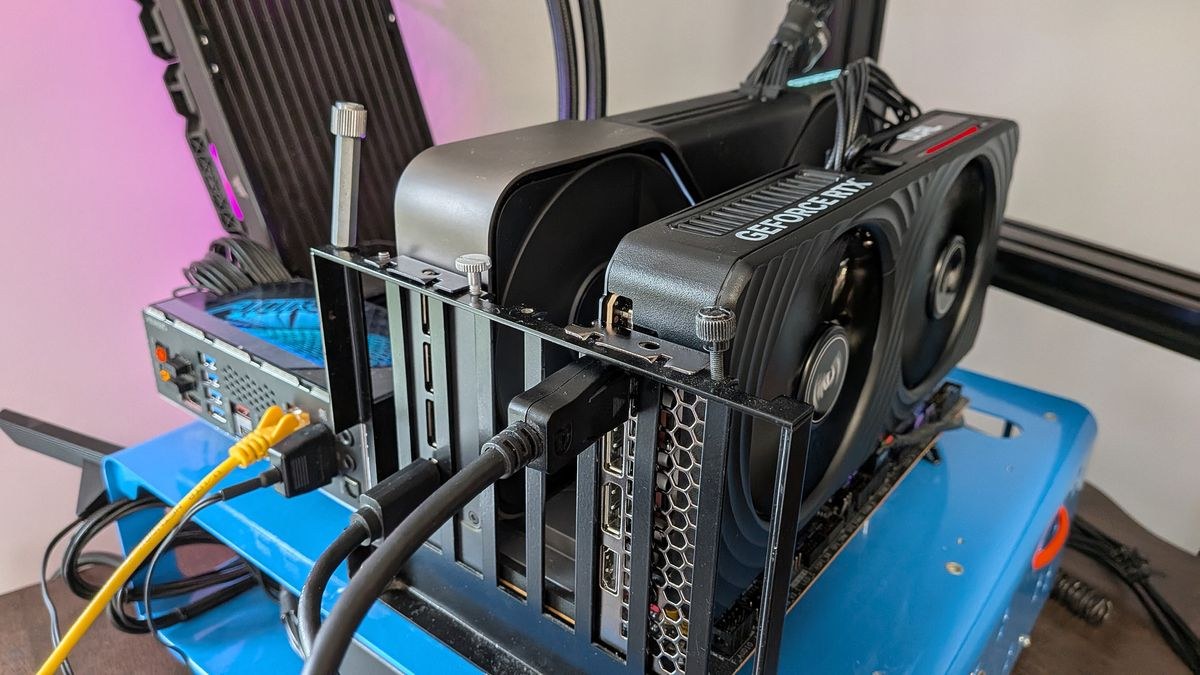 An RTX 5080 and RTX 5060 Ti graphics card in the same motherboard on an open test rig.