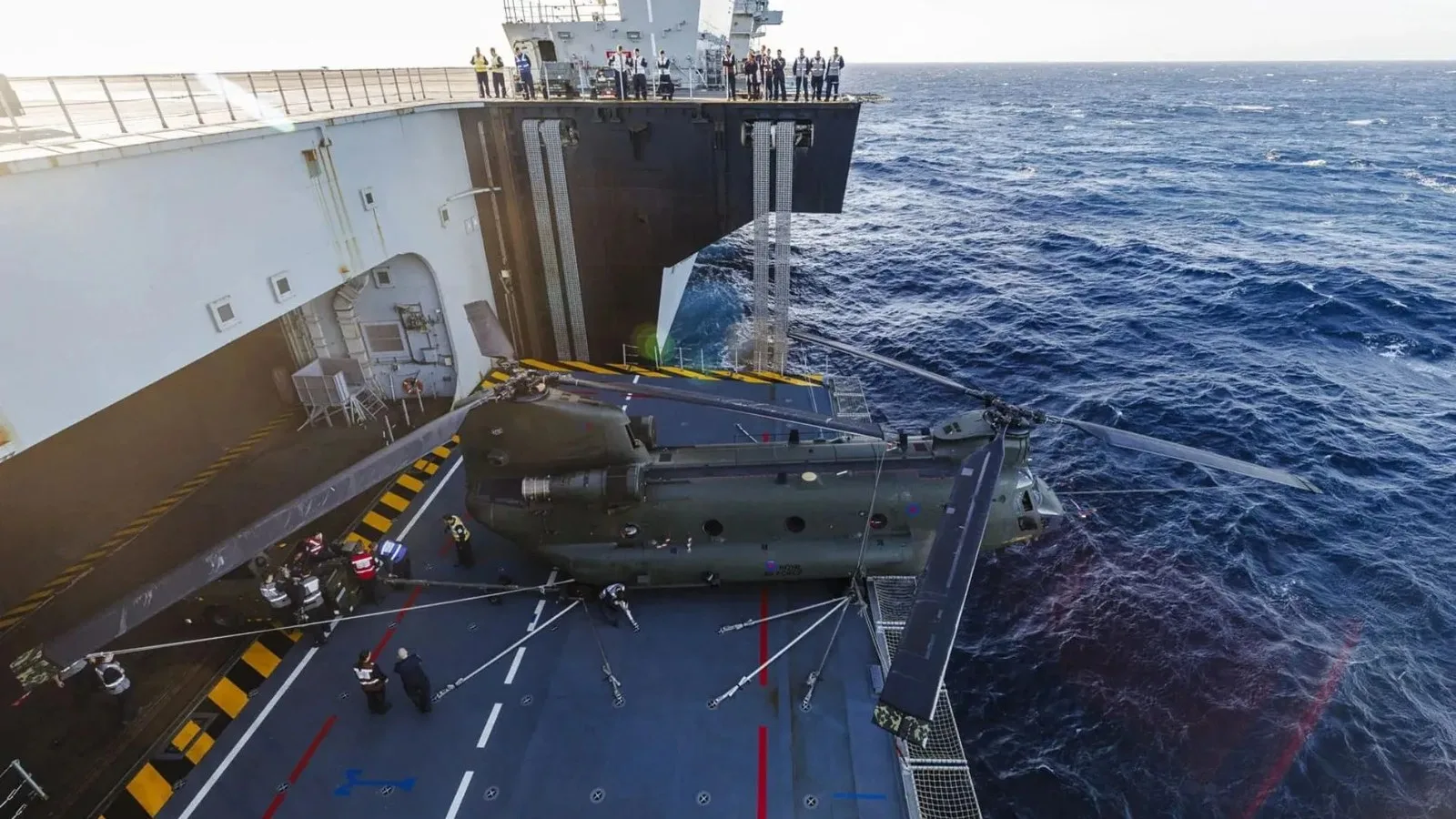 71,600-ton aircraft carrier trains Chinook helicopters for heavy-lift missions at sea At 99ft long, a Chinook – here ZH777 – just fits on the aircraft lift, its nose protruding over the edge, its rotors spread.